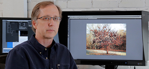 Man next to a CG2420 ColorEdge Monitor